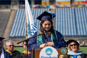 Jayanna smiling at the podium during the 2025 commencement ceremony.