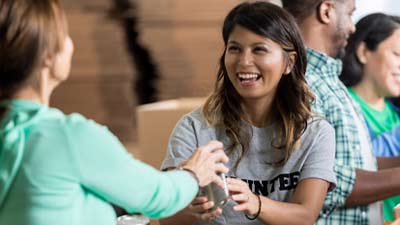 people working together to pack up boxes