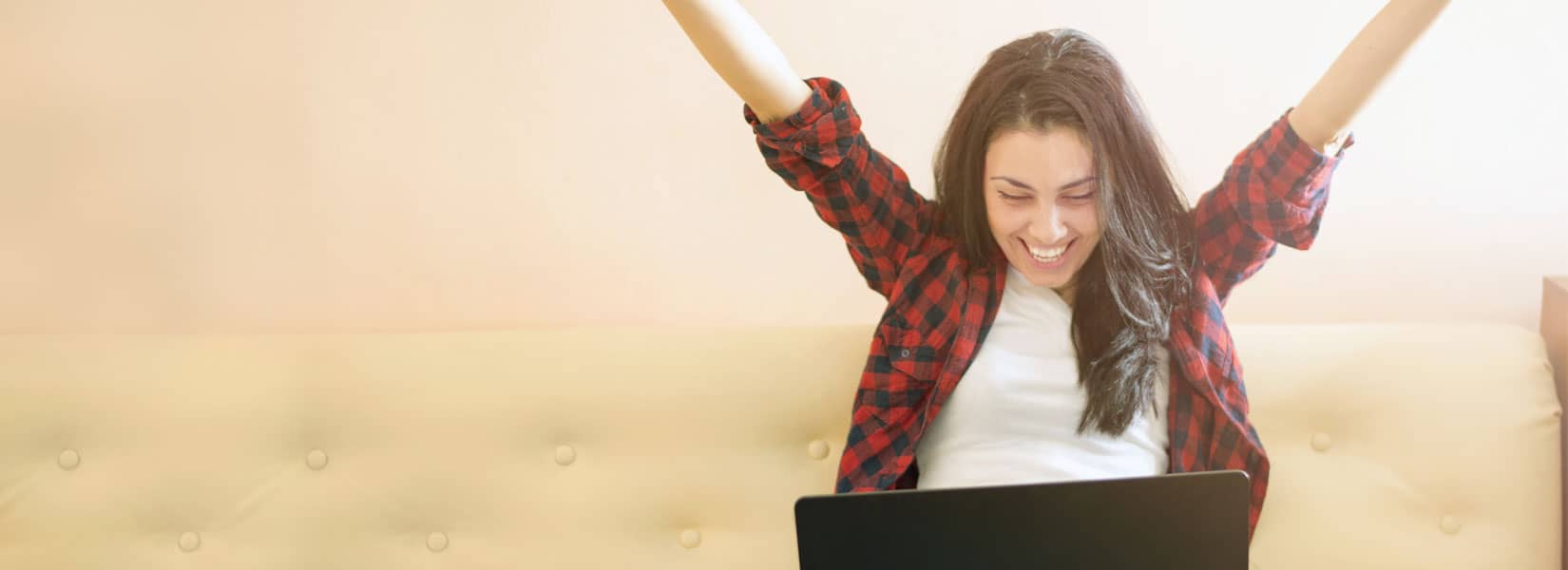 Student throwing their hands up in celebration